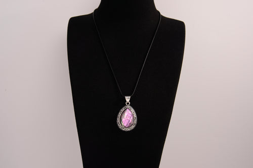 Raw Earth Crystals pink agate pendant with a teardrop-shaped design, featuring natural pink agate and an ornate silver-tone setting, promoting emotional balance, self-love, and gentle energy.