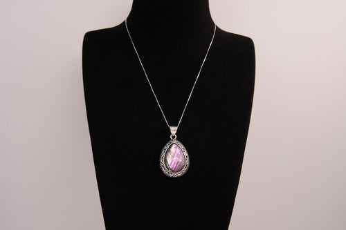 Raw Earth Crystals pink agate pendant with a teardrop-shaped design, featuring natural pink agate and an ornate silver-tone setting, promoting emotional balance, self-love, and gentle energy.