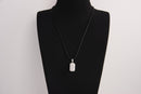 Raw Earth Crystals rectangle pendant featuring a polished opalite cabochon set on a sleek silver-toned bail, displayed on a black leather cord, symbolizing serenity, emotional balance, and spiritual insight.