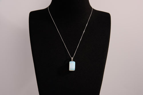 Raw Earth Crystals rectangle pendant featuring a polished opalite cabochon set in a sleek silver-toned bail, symbolizing serenity, emotional balance, and spiritual insight.