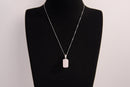 Raw Earth Crystals rectangle pendant featuring a polished rose quartz cabochon set in a sleek silver-toned bail, symbolizing love, compassion, and emotional healing.