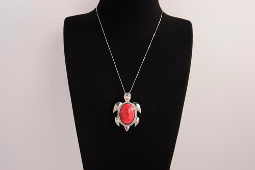 Raw Earth Crystals red howlite turtle necklace crafted from natural stone to support calm focus, stress relief, and emotional grounding.