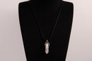 Raw Earth Crystals rose quartz necklace featuring a pointed natural stone pendant, designed to promote love, compassion, and emotional healing.