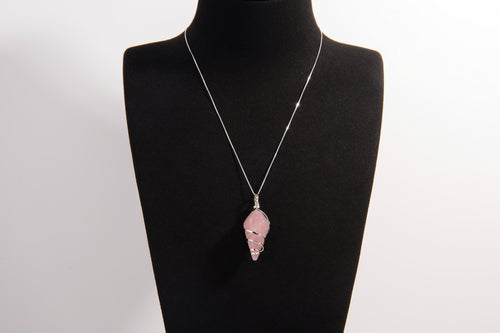 Raw Earth Crystals rose quartz pendant with a spiral wire wrap design, crafted from natural stone to foster love, compassion, and emotional healing.