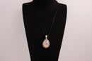 Raw Earth Crystals rose quartz pendant with a teardrop-shaped design, featuring natural rose quartz and an ornate silver-tone setting, promoting love, compassion, and emotional healing.