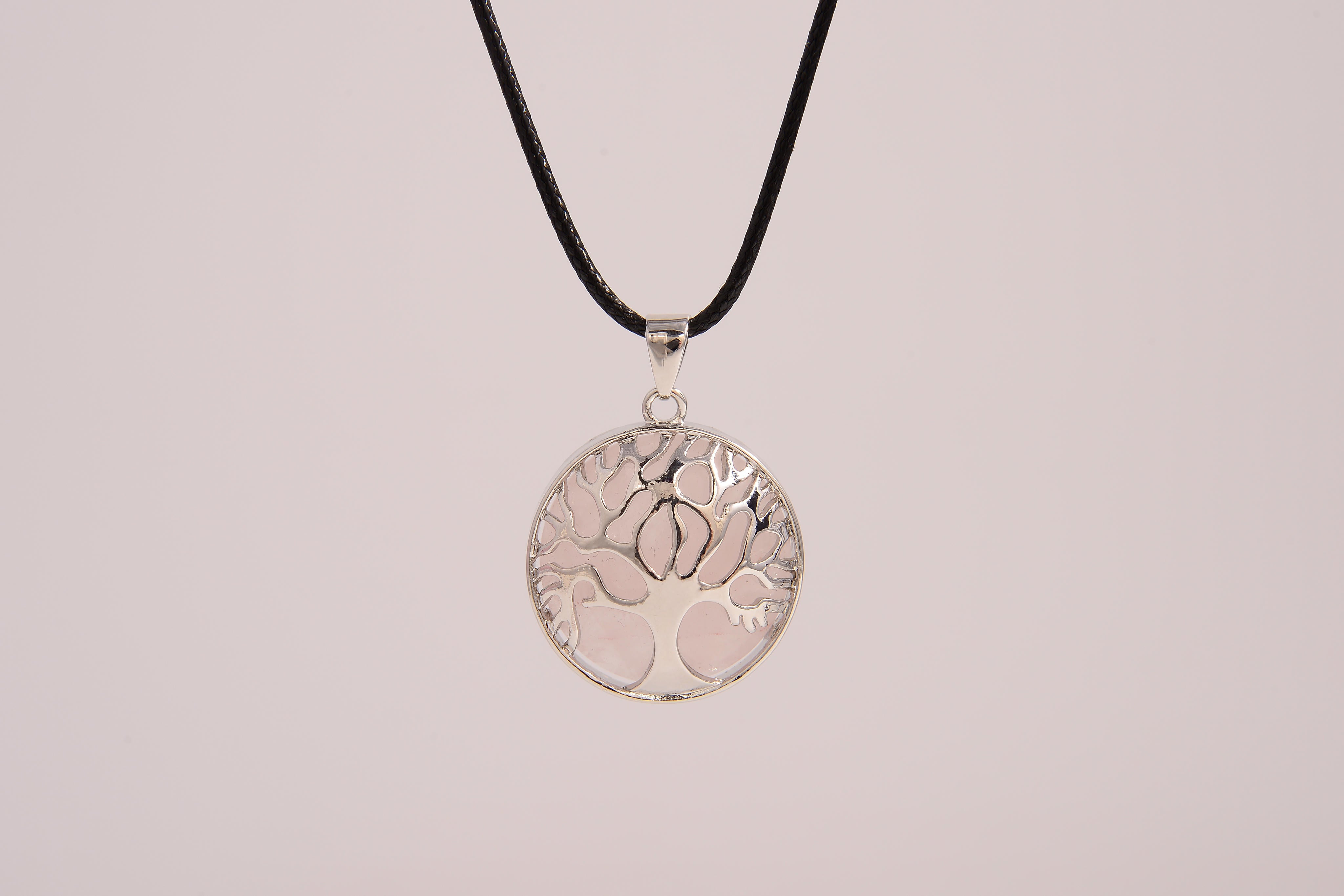 Raw Earth Crystals rose quartz pendant featuring a tree of life design, crafted with natural crystal for love, compassion, and emotional healing.