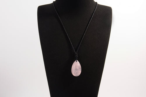 Raw Earth Crystals rose quartz teardrop pendant on black cord, crafted from natural rose quartz stone, promoting love, compassion, and emotional healing.