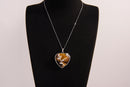 Raw Earth Crystals tiger eye heart pendant with an elegant rose design, featuring a rich golden-brown tiger eye stone and a silver-tone vine with leaves, promoting confidence, clarity, and personal power.