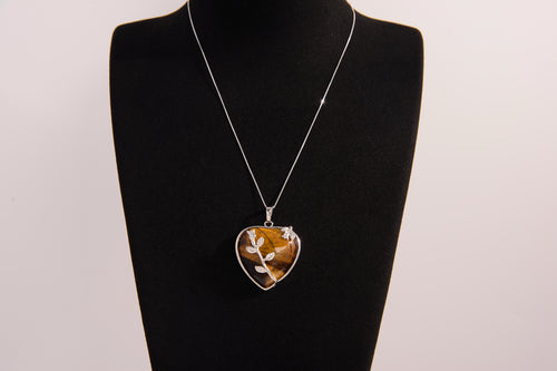 Raw Earth Crystals tiger eye heart pendant with an elegant rose design, featuring a rich golden-brown tiger eye stone and a silver-tone vine with leaves, promoting confidence, clarity, and personal power.