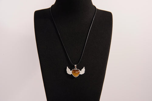 Raw Earth Crystals tiger eye heart with wings necklace, featuring a rich golden-brown heart-shaped stone adorned with delicate angelic wings, designed to enhance confidence, promote clarity, and support personal empowerment.