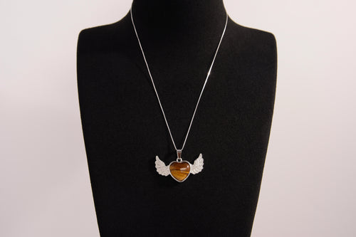 Raw Earth Crystals tiger eye heart with wings necklace, featuring a rich golden-brown heart-shaped stone adorned with delicate angelic wings, designed to enhance confidence, promote clarity, and support personal empowerment.