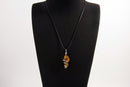 Raw Earth Crystals tiger eye pendant with a spiral wire wrap design, crafted from natural stone to promote confidence, protection, and grounding energy.