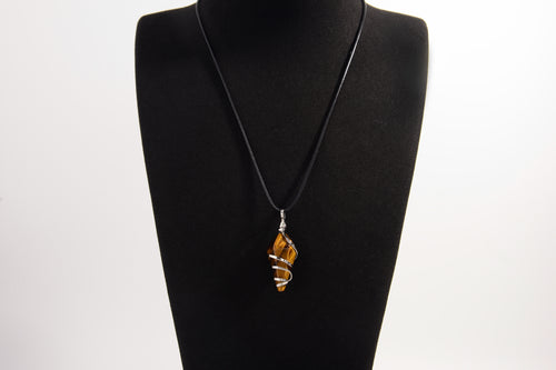 Raw Earth Crystals tiger eye pendant with a spiral wire wrap design, crafted from natural stone to promote confidence, protection, and grounding energy.