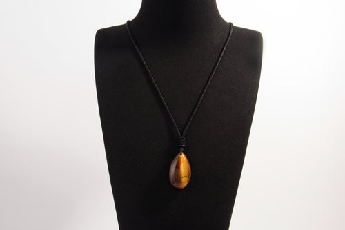 Raw Earth Crystals tiger eye teardrop pendant on black cord, crafted from natural tiger eye stone, promoting confidence, focus, and personal power.