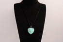 Raw Earth Crystals turquoise heart pendant with an elegant rose design, featuring a vibrant turquoise stone and a silver-tone vine with leaves, promoting communication, creativity, and emotional balance.