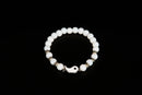 White jade beaded bracelet with yin yang charm from Raw Earth Crystals, featuring natural gemstones for balance, harmony, and spiritual alignment.