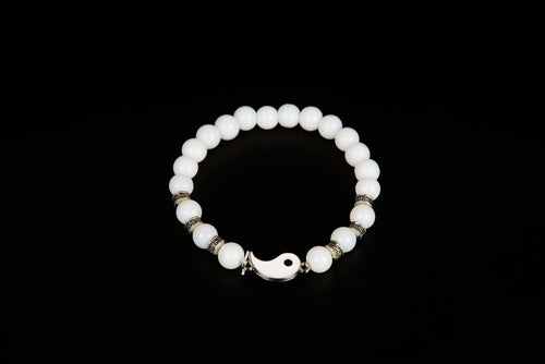 White jade beaded bracelet with yin yang charm from Raw Earth Crystals, featuring natural gemstones for balance, harmony, and spiritual alignment.